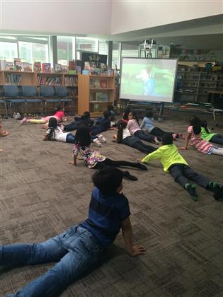 Children watching an educational video in the library