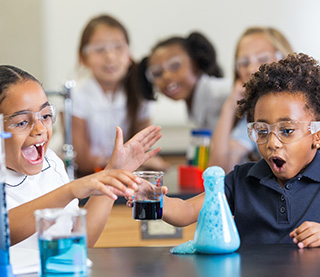 Young students enthralled in a classroom chemistry experiment