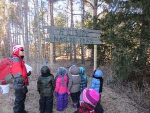 Students looking at Hillside Nature Sign
