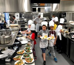 Waterfront students cooking in George Brown Cooking School Kitchen