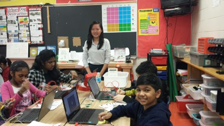 students smiling for the camera while working on their circuits at Makey Makey