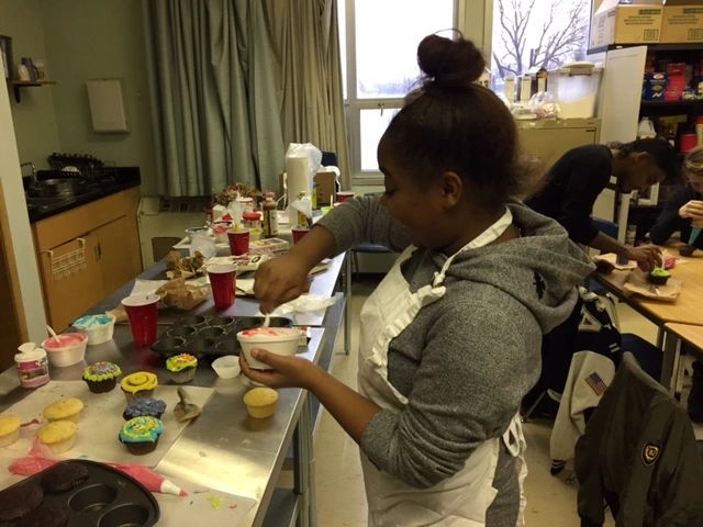 Student making cupcakes Open Gallery