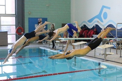 Swimmers diving into watter Open Gallery