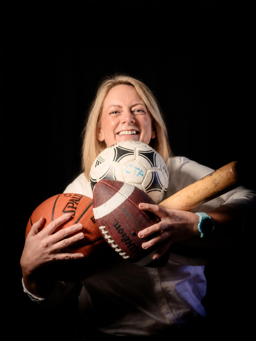 woman holding sports equipment