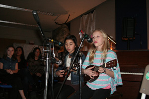 two students playing ukuleles