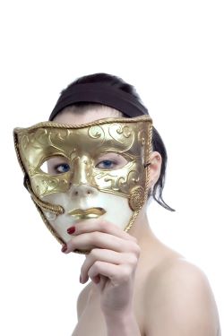 person holding drama mask in front of the face