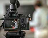 Video Camera pointing at a teacher in a classroom