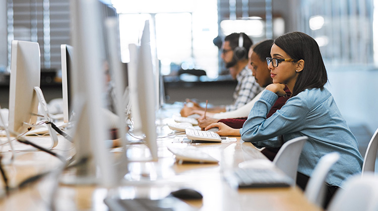 High school students concentrate on their individual computer related tasks