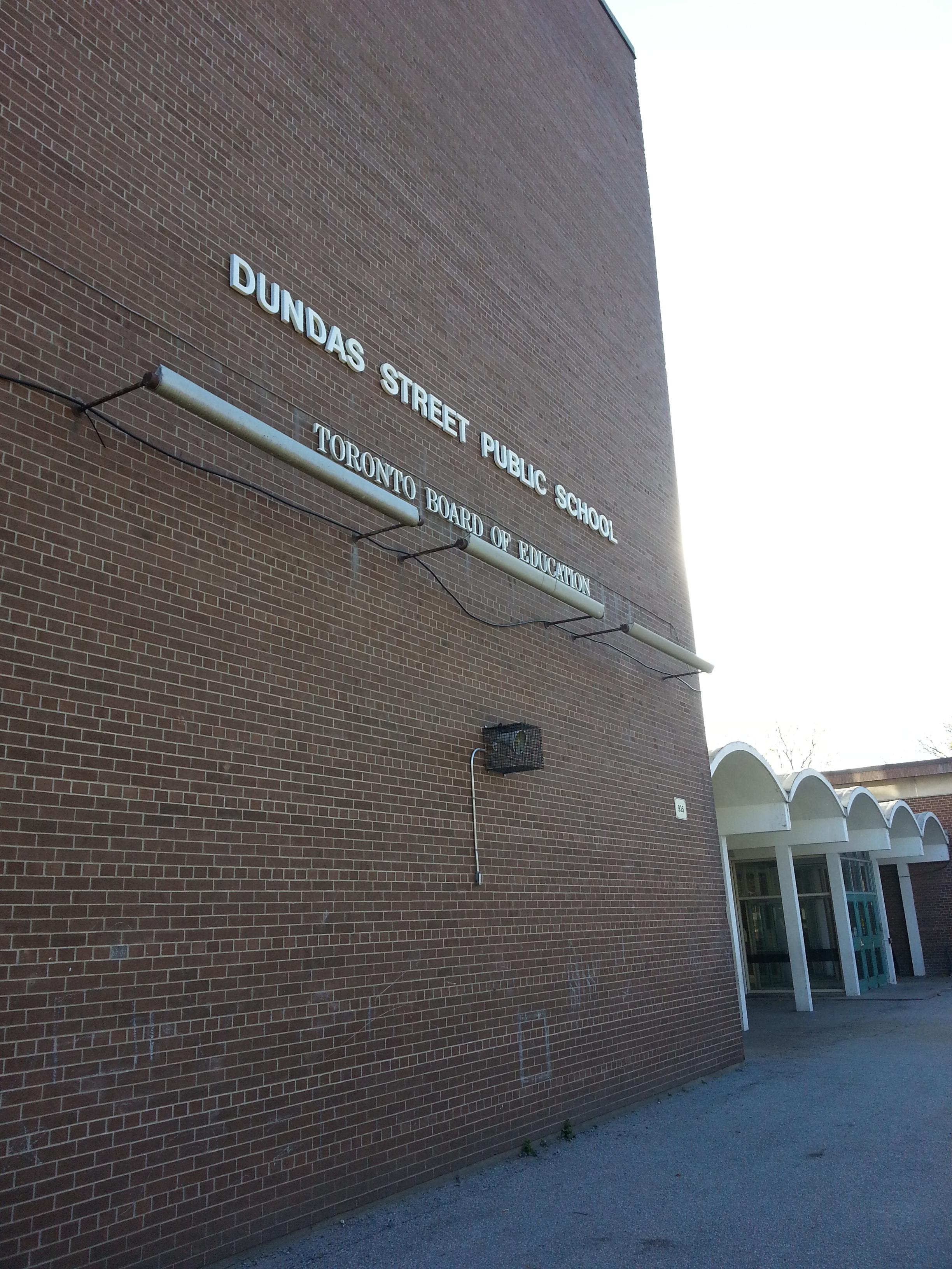 Photo of the front of the building and school name