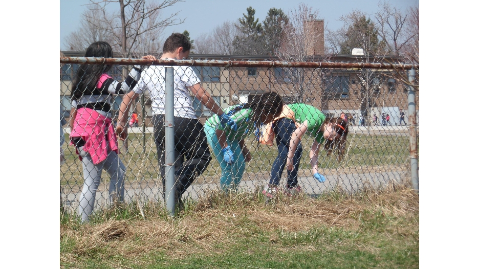 Students and staffs clean the school yard