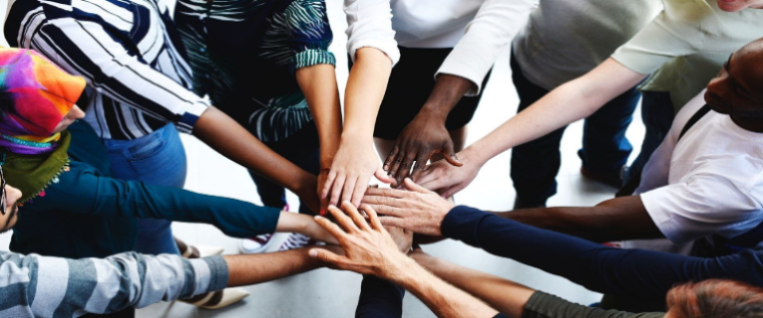 staff joining hands