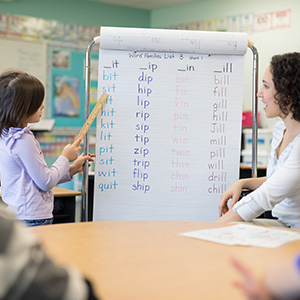 A teacher engages a young student in a grammar lesson