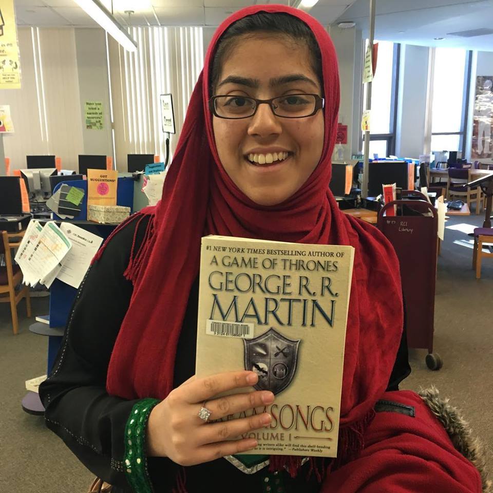 student holds a book