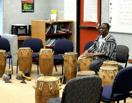 Kwasi demonstrating African Drumming