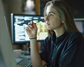 A female student is immersed in her computer screens